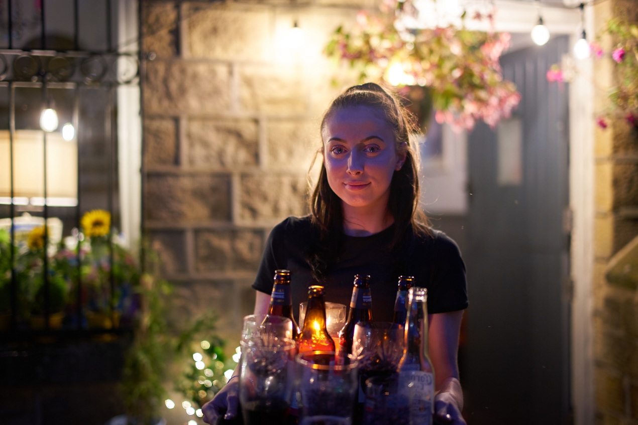 Waitress in candlelight - photo by Ian Tragen